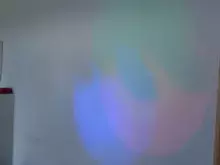 cień dłoni na oświetlonej kolorami ścianie